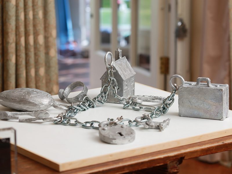 Charms made by artist Paul Coldwell - a suitcase, a padlock and a house are