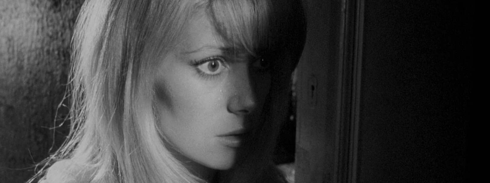 Catherine Deneuve in Repulsion film Roman Polanski, uncanny, woman's face is submerged in shadow